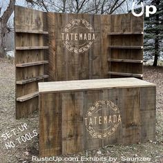 an old wooden box with the word tatema written on it in front of some trees