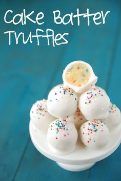 cake batter truffles on a plate with sprinkles and white frosting