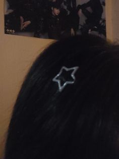 the back of a woman's head with a hair clip in front of her