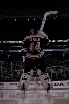 an image of a hockey player getting ready to hit the puck in front of fans