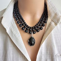 Introducing our Handmade Black Onyx Beaded Necklace, a stunning accessory designed for women who love to make a statement with their jewelry. This multi-strand piece features natural black onyx stones, creating an elegant and boho chic look that is sure to turn heads. The perfect gift for a loved one or a special treat for yourself, this necklace is a versatile addition to any wardrobe. CARE INSTRUCTIONS: To keep your necklace looking its best, avoid contact with water and harsh chemicals. Store Black Necklace Elegant, Layered Beaded Necklaces, Delicate Pendant, Jewelry Elegant, Boho Chic Jewelry, Onyx Necklace, Black Onyx Stone, Black Accessories, Onyx Bead