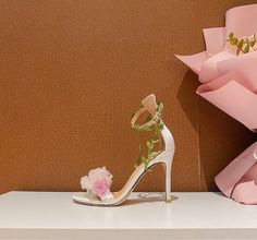 Step into a garden of elegance with the Claire Floral Heels. These stunning heels feature a delicate pink base adorned with intricate floral details, making them the perfect accessory for a romantic and feminine look. The ankle strap is beautifully decorated with green leaf accents, adding a whimsical touch that complements the soft, ethereal flowers on the toe. Crafted with a satin finish, the Claire Floral Heels offer a luxurious feel and a comfortable fit. The open-toe design showcases your p Flower High Heels, High Heels Pink, Heels Strappy, Party Models, Chiffon Flower, Baby Hair Clips, Pink Chiffon, Chiffon Flowers, Ankle Strap Shoes