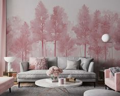 a living room with pink and grey decor on the walls, couches and tables