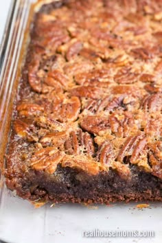 a close up of a cake in a pan with pecans on the top and bottom