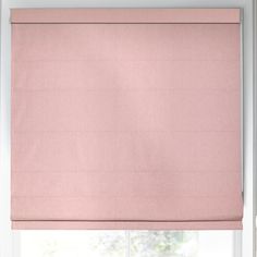 a pink roman blind hanging on the side of a window