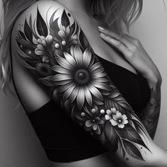 black and white photo of a woman's arm with flower tattoos on her arms