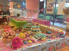 a table filled with lots of cupcakes and other treats on top of it