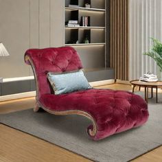 a red chaise lounge chair sitting on top of a rug in a living room