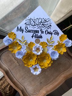 a graduation cap decorated with paper flowers