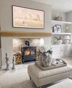 a living room filled with furniture and a fire place in front of a painting on the wall