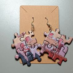 two pieces of puzzle sitting next to each other on top of a piece of cardboard