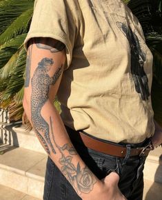 a man with a leopard tattoo on his arm