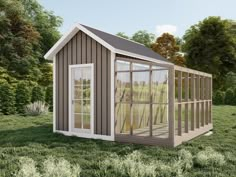 a small shed sitting on top of a lush green field