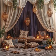 a living room filled with lots of pillows and furniture covered in drapes next to candles