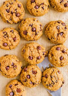 chocolate chip cookies on parchment paper with a spatula