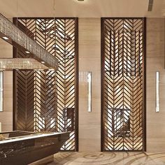 an elegantly decorated lobby with marble floors and wooden partitions on the walls, along with chandeliers