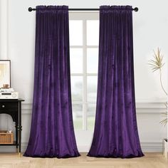 the purple curtains in this room are ready to be hung on the window sill