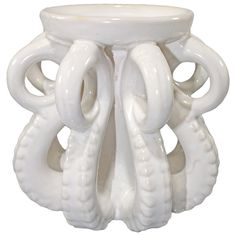 a white ceramic vase with an intricate design