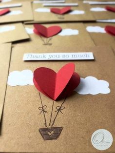 some red hearts are attached to brown envelopes