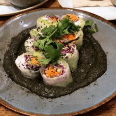 a plate with some food on it sitting on a table next to other plates and utensils