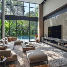 a living room with couches, tables and a large window that looks out onto the pool