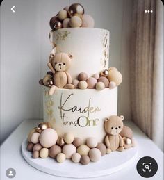 a three tiered cake with teddy bears on top