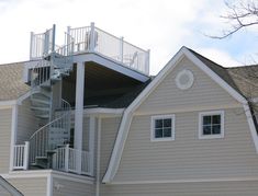 a house with stairs leading up to the roof