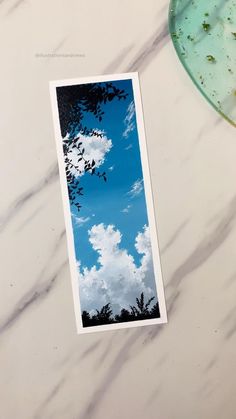 an image of the sky and clouds taken from below on a marble counter top with a plate