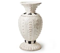 an ornate white vase with black accents on the top and bottom, is shown against a white background