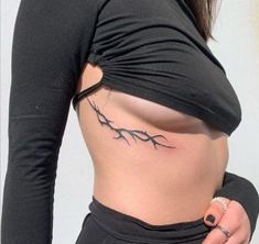 a woman with a tattoo on her stomach and the top half of her body is shown