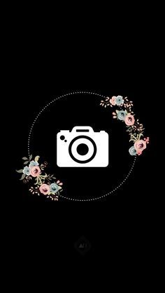 a camera with flowers around it on a black background