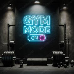 a gym room with neon sign and barbells