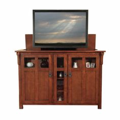 a flat screen tv sitting on top of a wooden cabinet