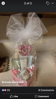 a gift basket for someone's birthday is displayed on the counter in front of her phone