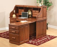 a wooden desk with drawers and a laptop on it