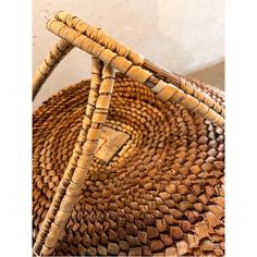 a close up of a basket on the floor with wood sticks sticking out of it