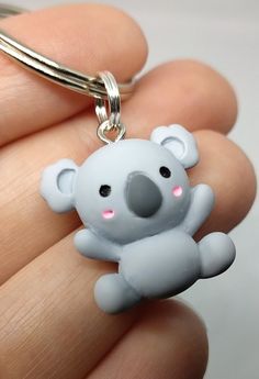 a small key chain with a koala on it