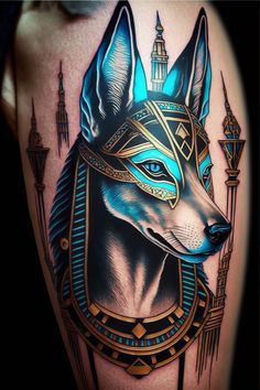 an egyptian tattoo design on the back of a man's arm, with blue eyes and headdress