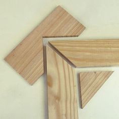 three pieces of wood sitting next to each other on top of a white countertop