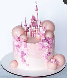 there is a cake decorated with pink and purple decorations on the top of this cake