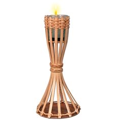 a wicker candle holder with a lit candle in the center on a white background