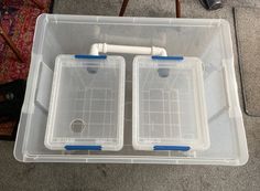 two plastic containers sitting on top of a carpeted floor