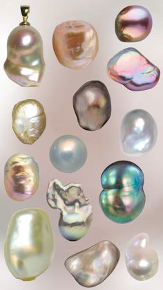 an assortment of different colored pearls on a white background