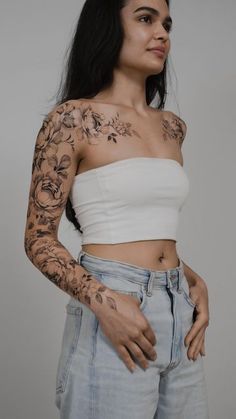 a woman with tattoos on her arms and shoulder