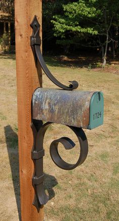 a mailbox attached to a wooden post