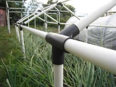 a white and black metal fence in the grass