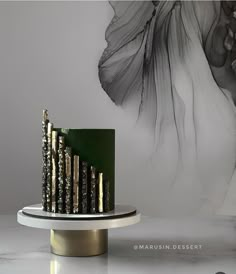 the cake is decorated with gold and green icing