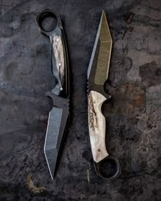 two knives are laying next to each other on the ground, one has been cut in half