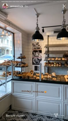 an image of a bakery setting with pastries on the counter and lights hanging from the ceiling