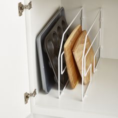 two kitchen utensils hanging on the wall next to each other in a cupboard